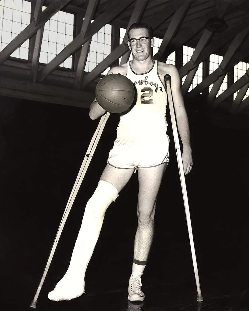 Young Doyle Brunson with a basketball and clutches after the accident.